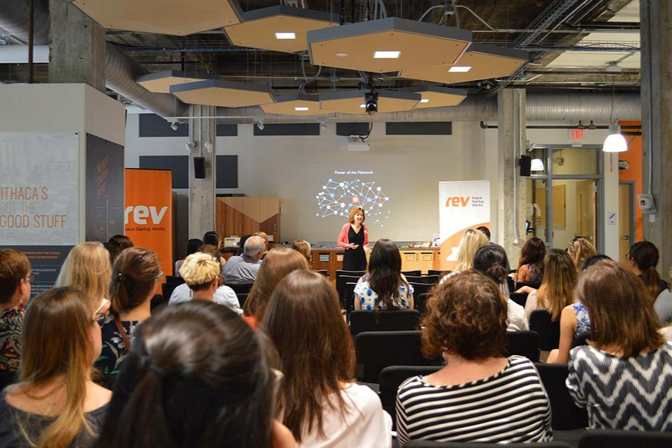 Seated attendees at networking night listen to Rev member company Ursa pitch